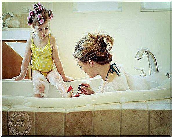 Mother and daughter in bathtub