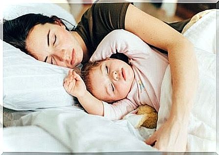 Mother and child sleeping together