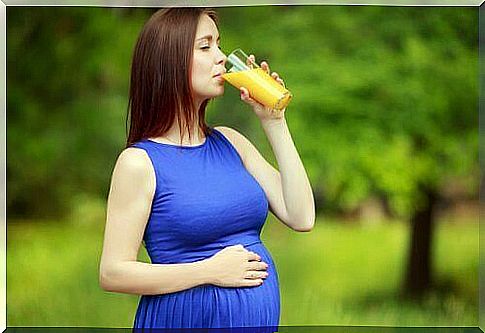 pregnant woman drinking juice