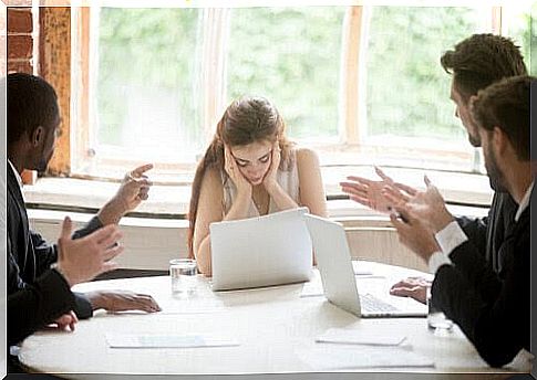 emotional wounds from childhood: woman looks stressed at meeting