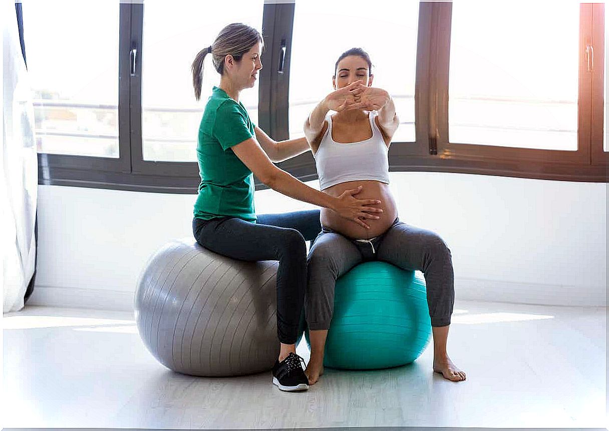 A pregnant woman in a prenatal exercise class, sitting on an exercise ball.