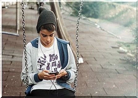 teenager on swing with mobile