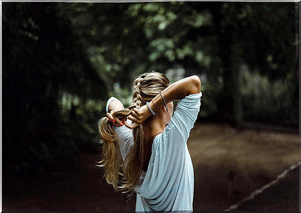 woman braids her hair