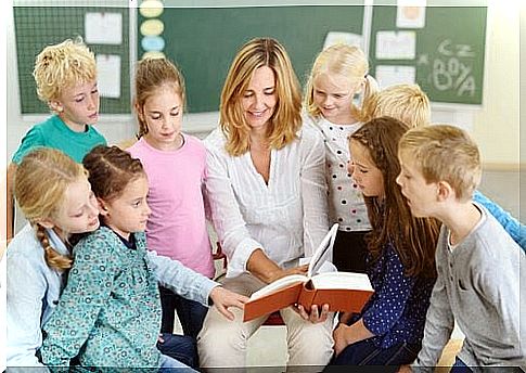 Woman reading book to a group of children