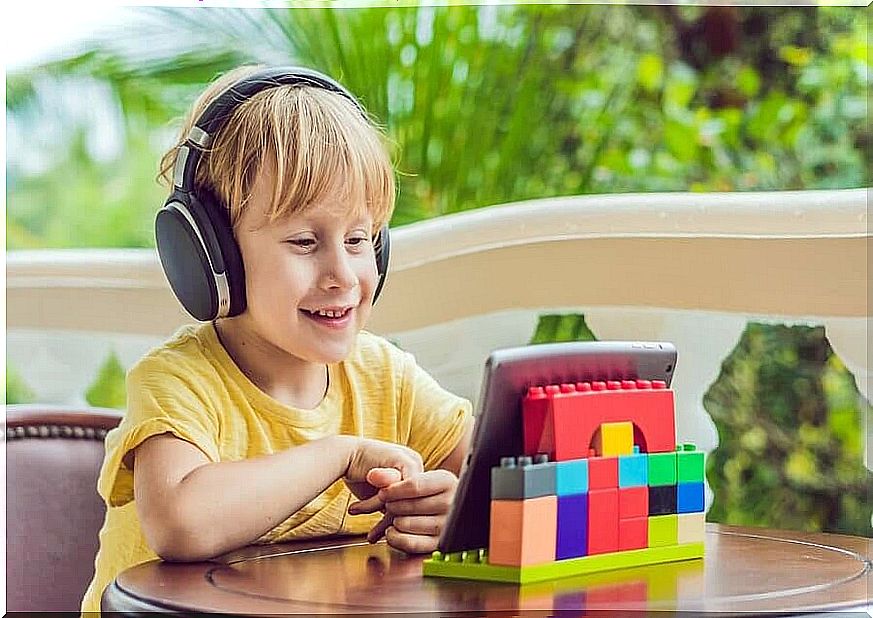 boy with headphones and iPad