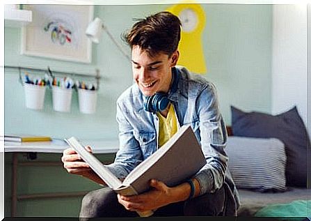 A teenager reading a book.