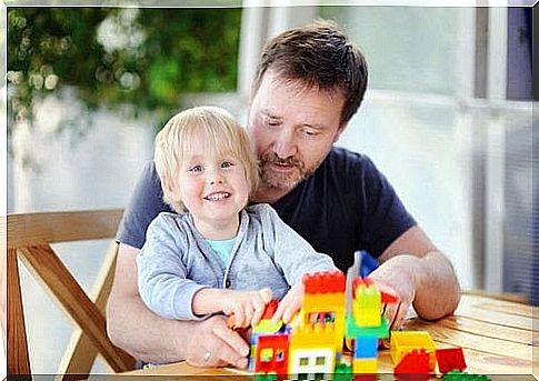 children, father and building blocks