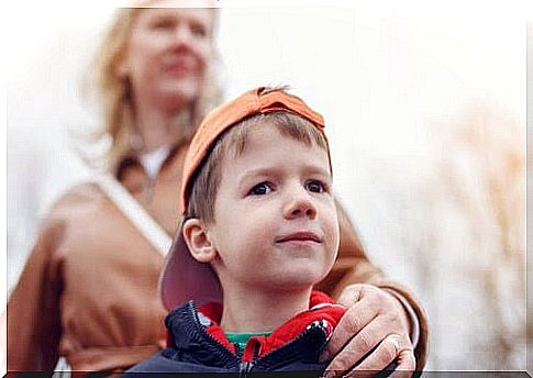 Overprotective parenting: mother holds child's shoulder