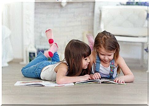 teach children to hate reading: two children lying on the floor and looking in book