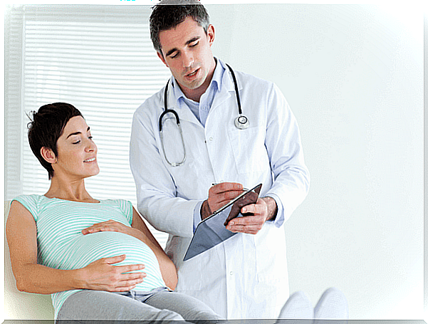 Pregnant woman with doctor