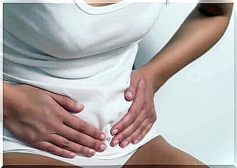 premenstrual syndrome: woman sticks to her stomach