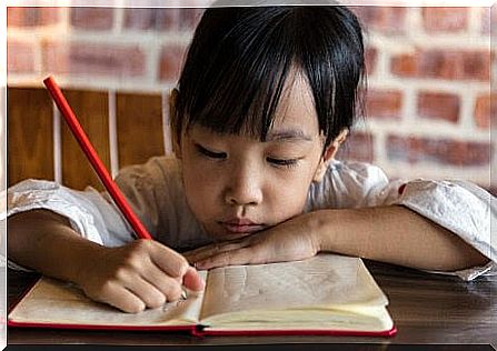 girl writes in book