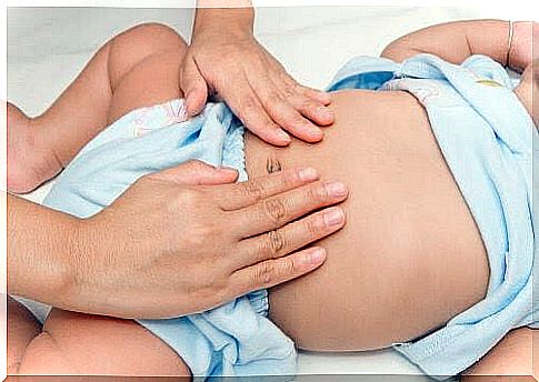 hands examining baby's belly