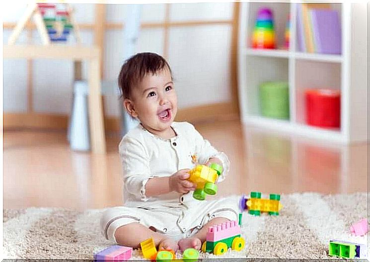 children's motor skills: baby playing with toys