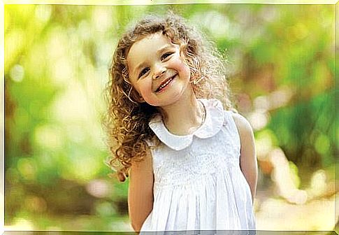 happy girl with curly hair in summer dress