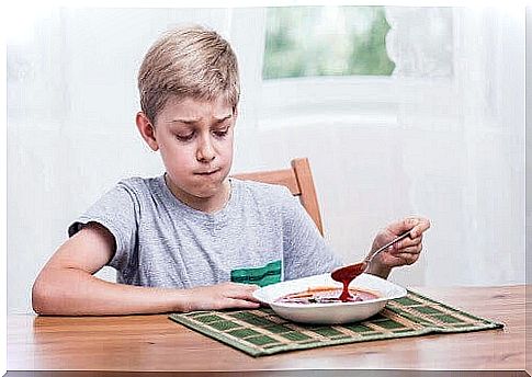 food preferences: boy looks skeptically at soup