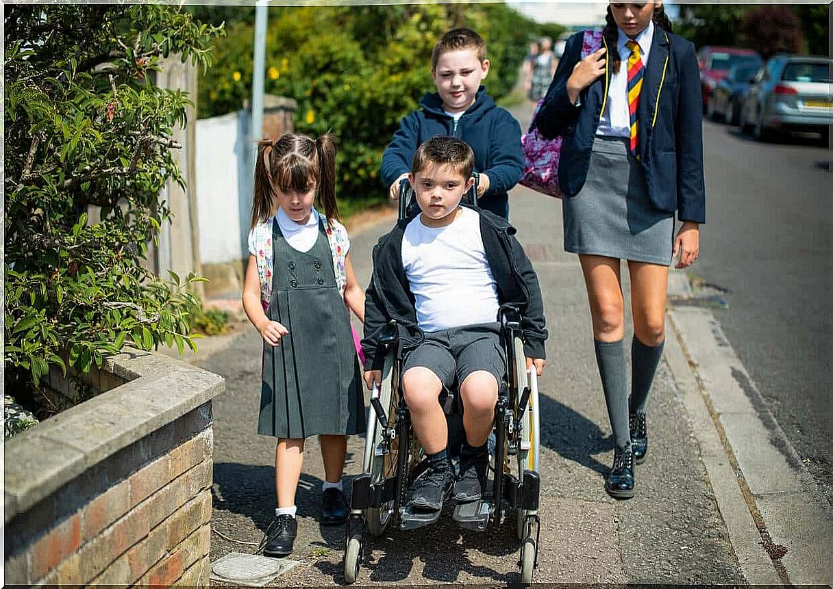 A child in a wheelchair going to school.