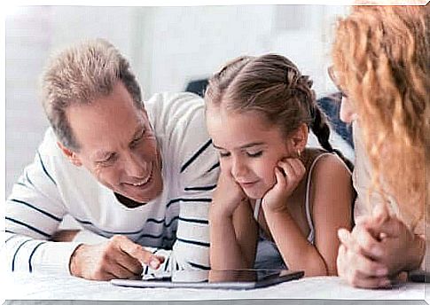 bring up their children: mother, father and daughter looking in book together