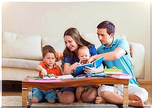 bring up their children: family sitting at coffee table and playing