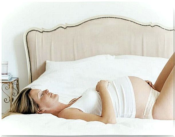 pregnant woman relaxing on bed