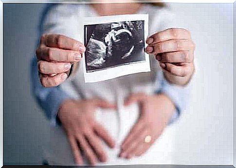 Perinatal psychology: couple holding up ultrasound image