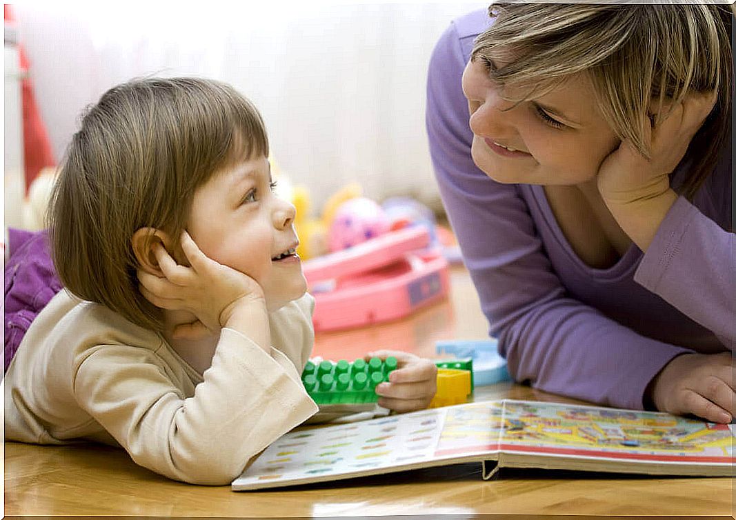 boy and woman discussing over a book