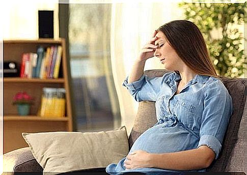 pregnant woman on sofa, looking tired