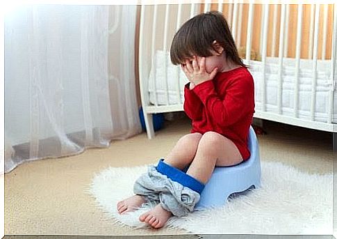 Little girl on potty with hands for face