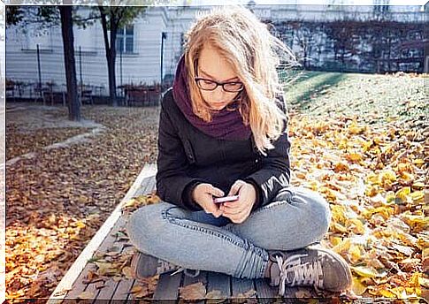 teenager checks social media on his mobile