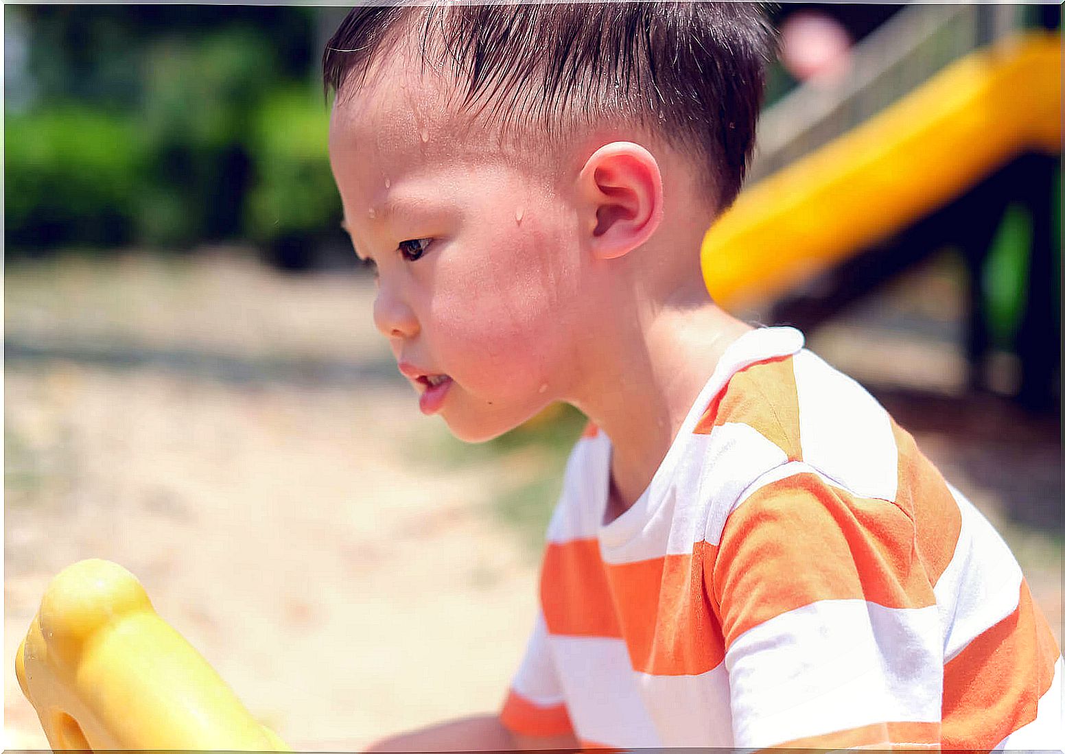 Boy sweats a lot because he plays in the sun.