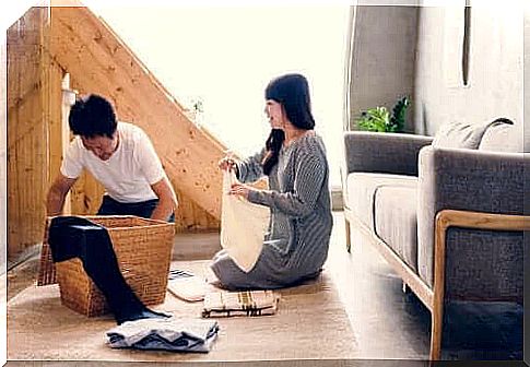 mental workload: man and woman fold laundry