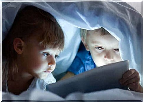 negative effects such as screen time: children under cover with tablet