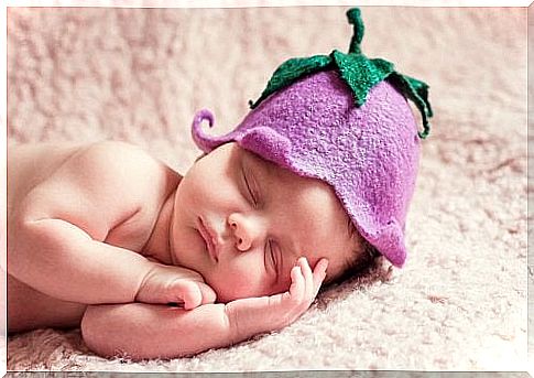 Baby sleeping with hat.