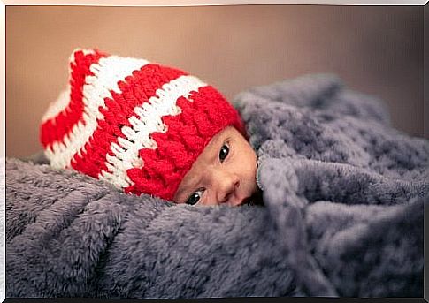 Baby wrapped in blanket.