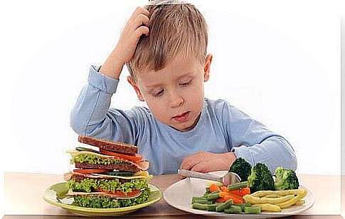 boy looks at food and scratches his head