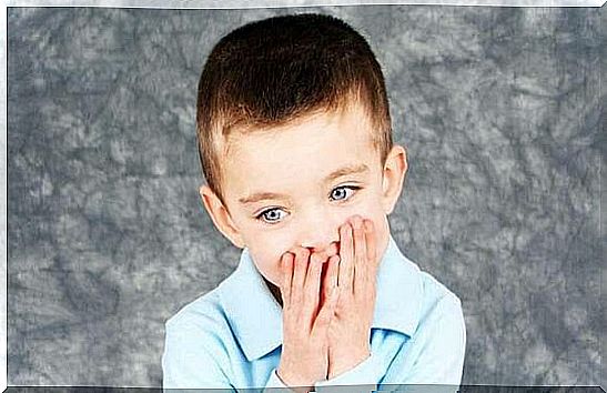 boy with hands in mouth