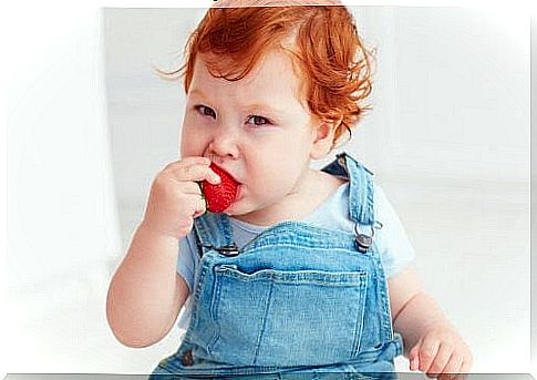 baby eats strawberry