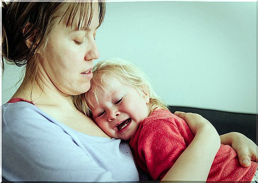 Mother comforts crying children