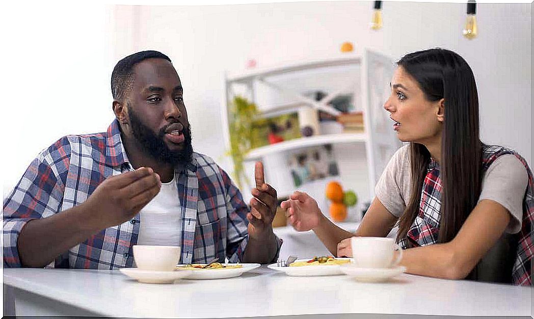 become friends again: couple arguing at the kitchen table