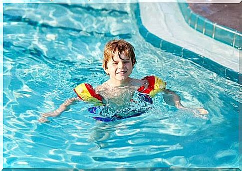 boy with floats in pool